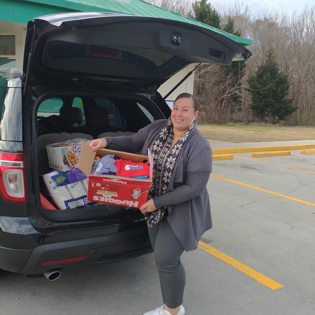 Woman carrying box of volunteer goods