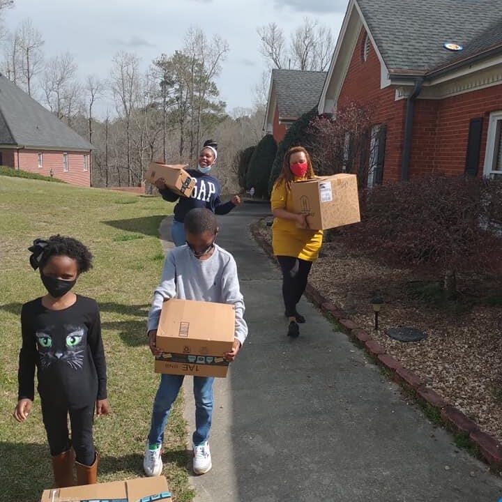 Young people carrying boxes of donations