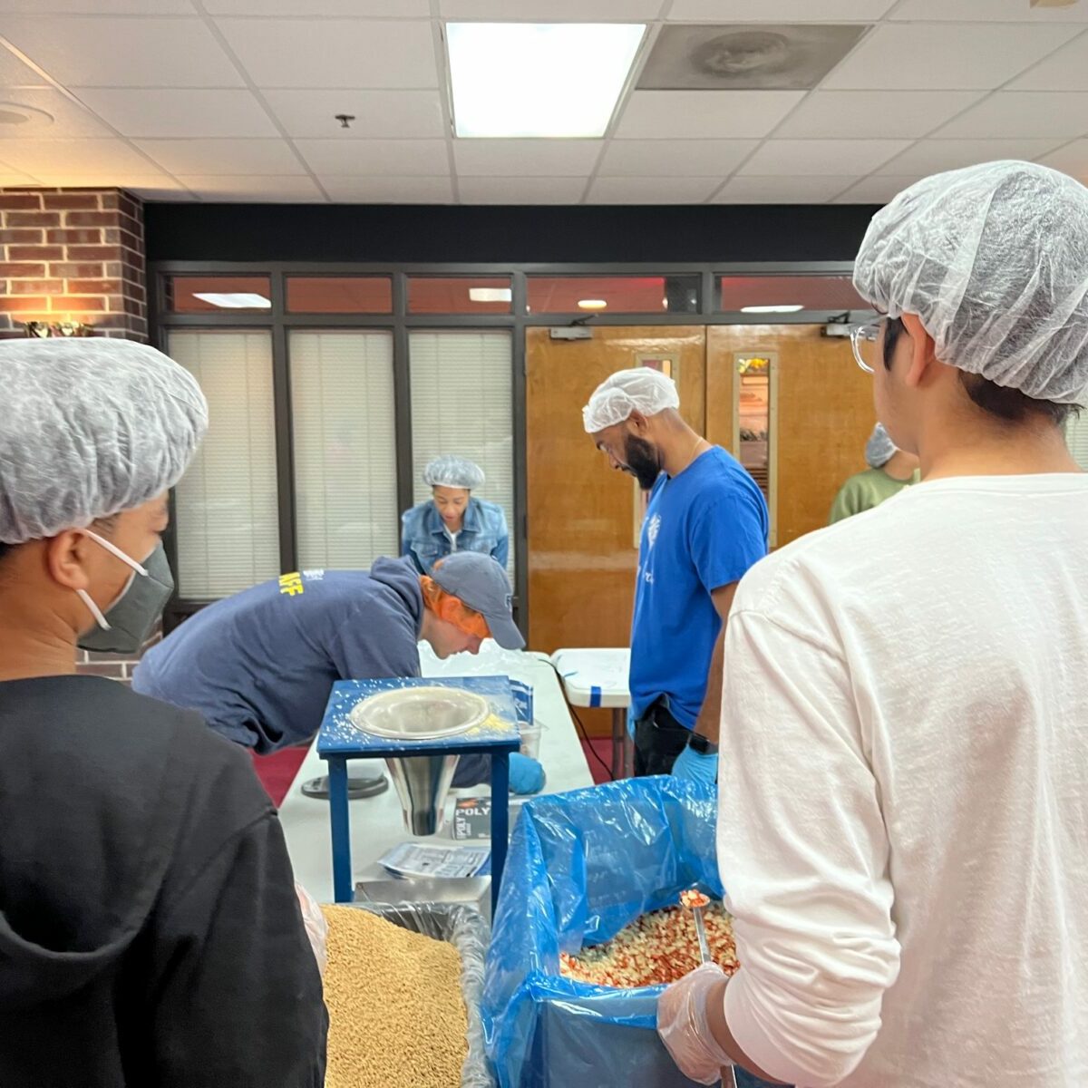 Young people volunteering at a kitchen event